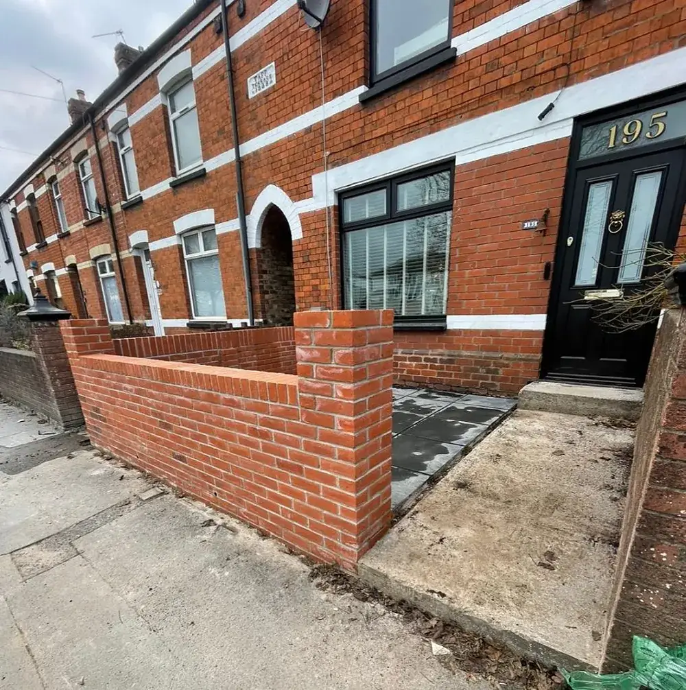 Rebuilt red brick front wall with new piers in front of a terraced house