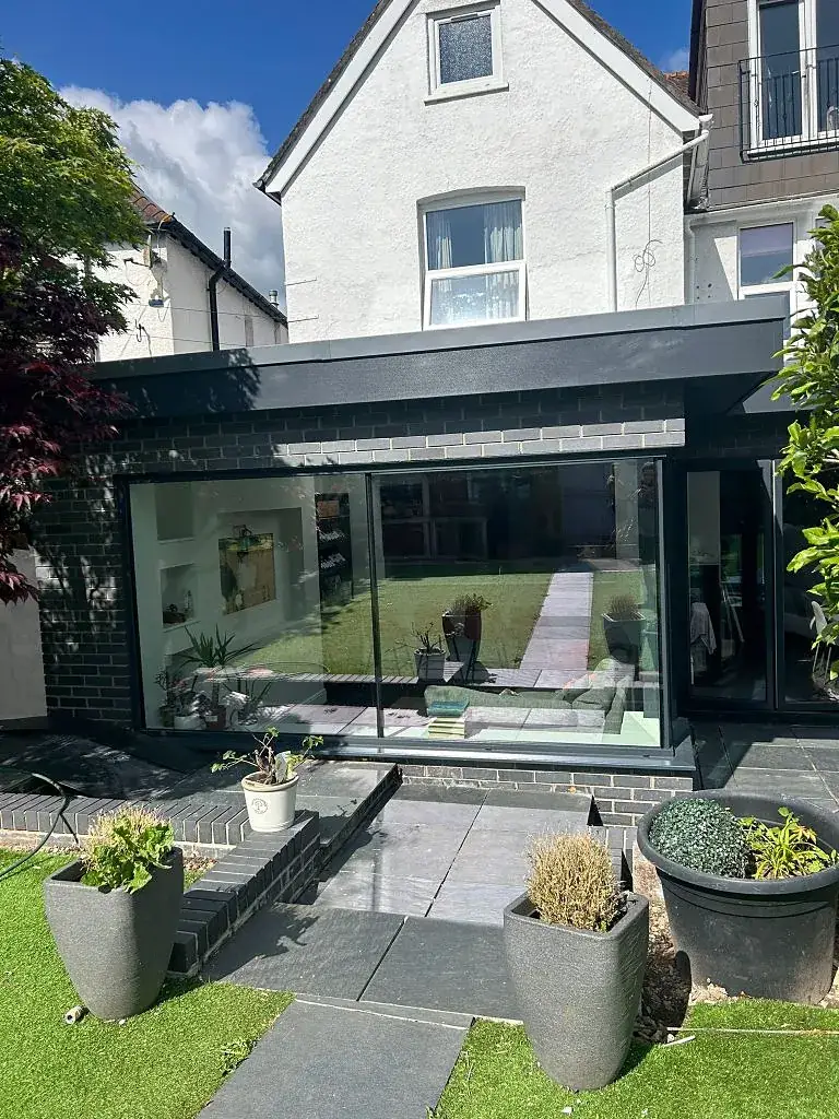 Contemporary flat-roof rear extension with floor-to-ceiling glazing