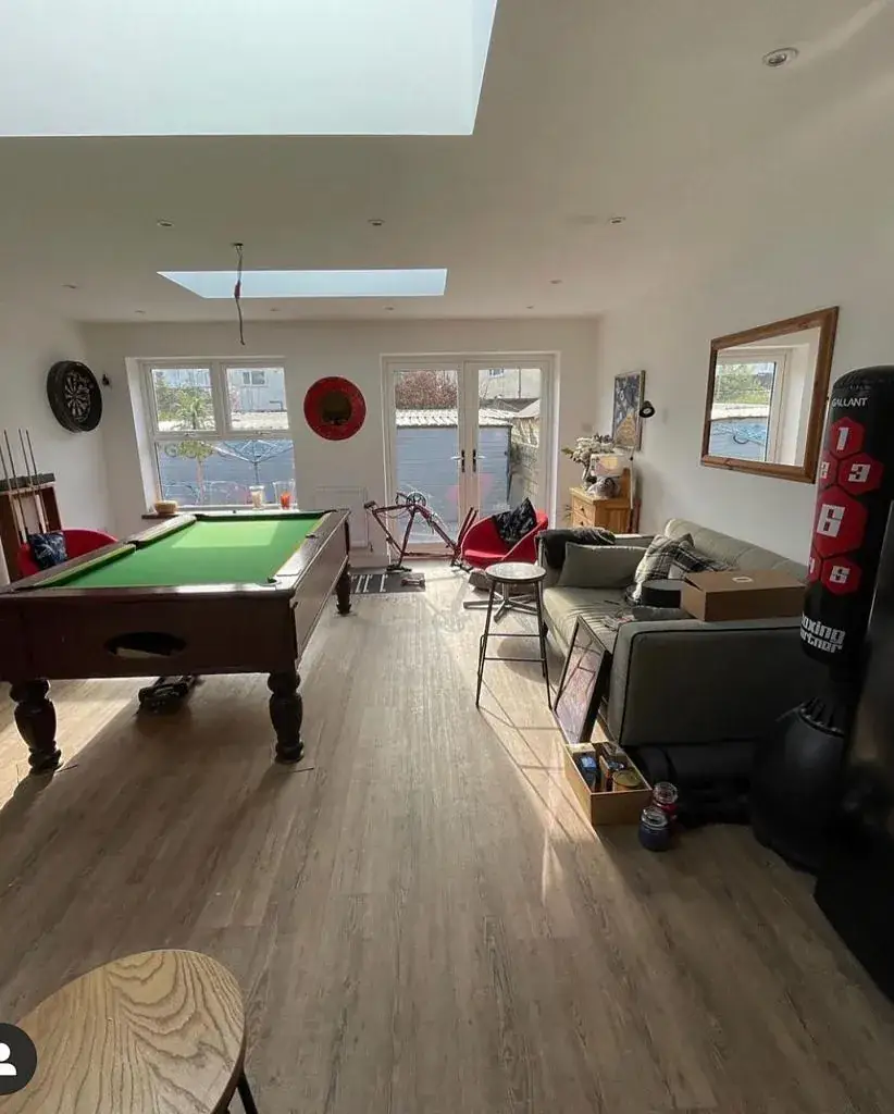 Converted room in use as a games room with a pool table under a rooflight