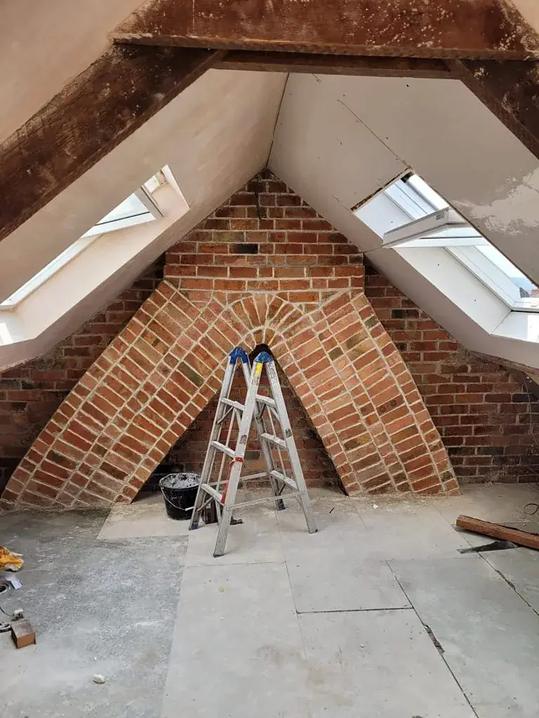 Roof space opened up during a loft conversion with the brickwork exposed