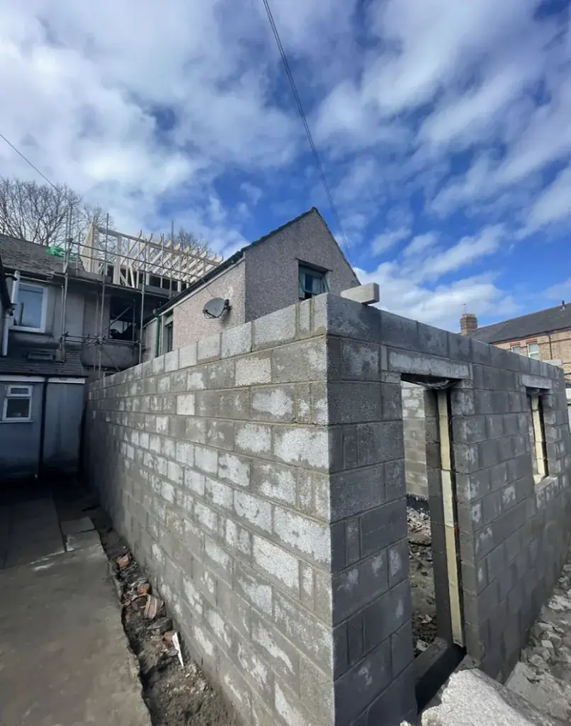 Blockwork shell of a new building with scaffolding alongside