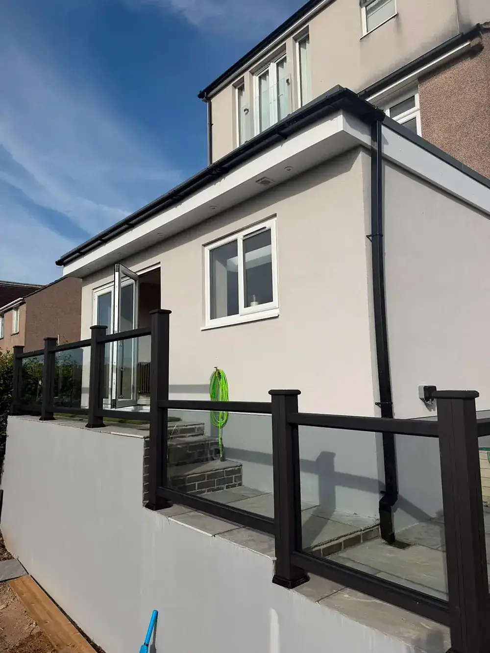 Rendered rear elevation with a raised terrace and glass balustrade