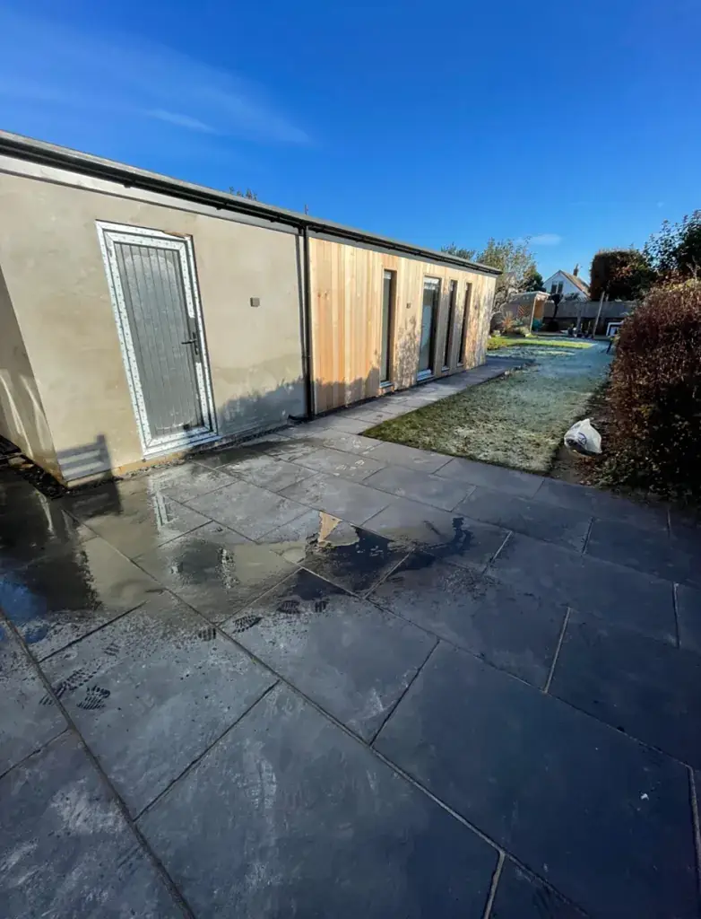 Single-storey rear extension with new paving alongside it