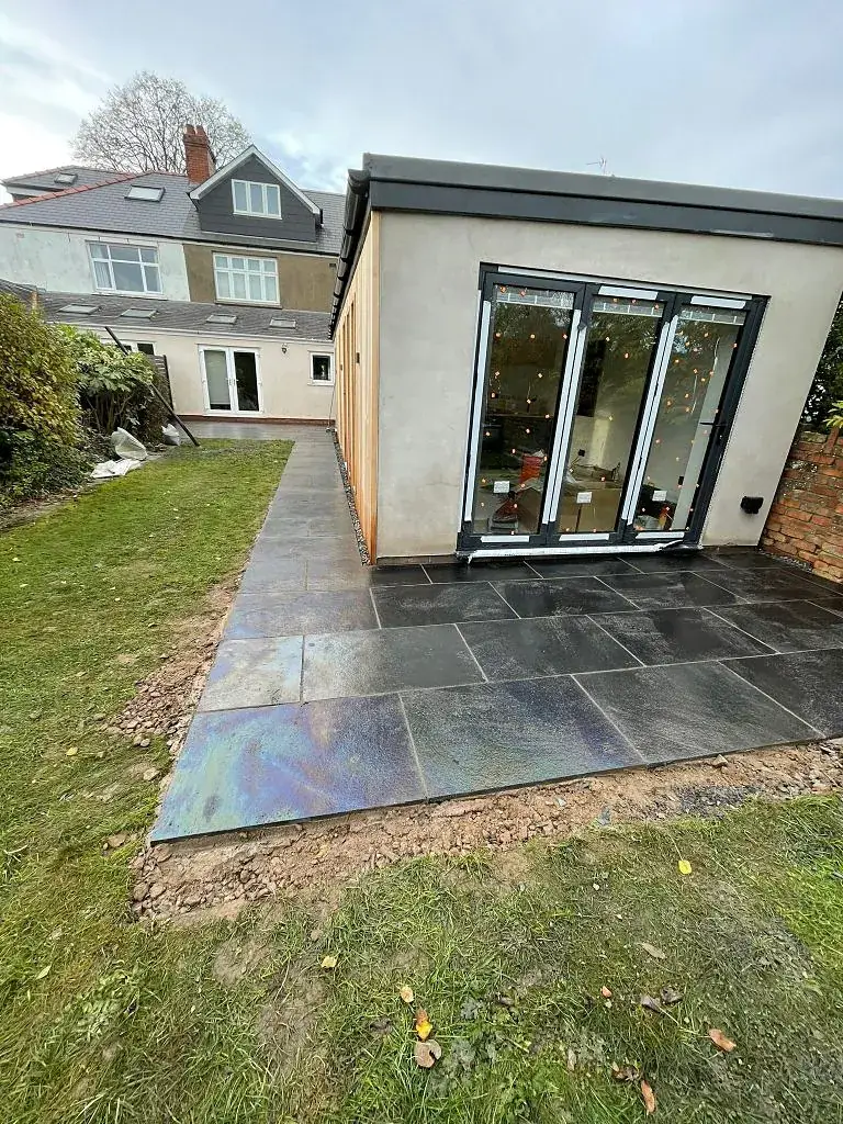 Slate path running alongside a rear extension with bi-fold doors