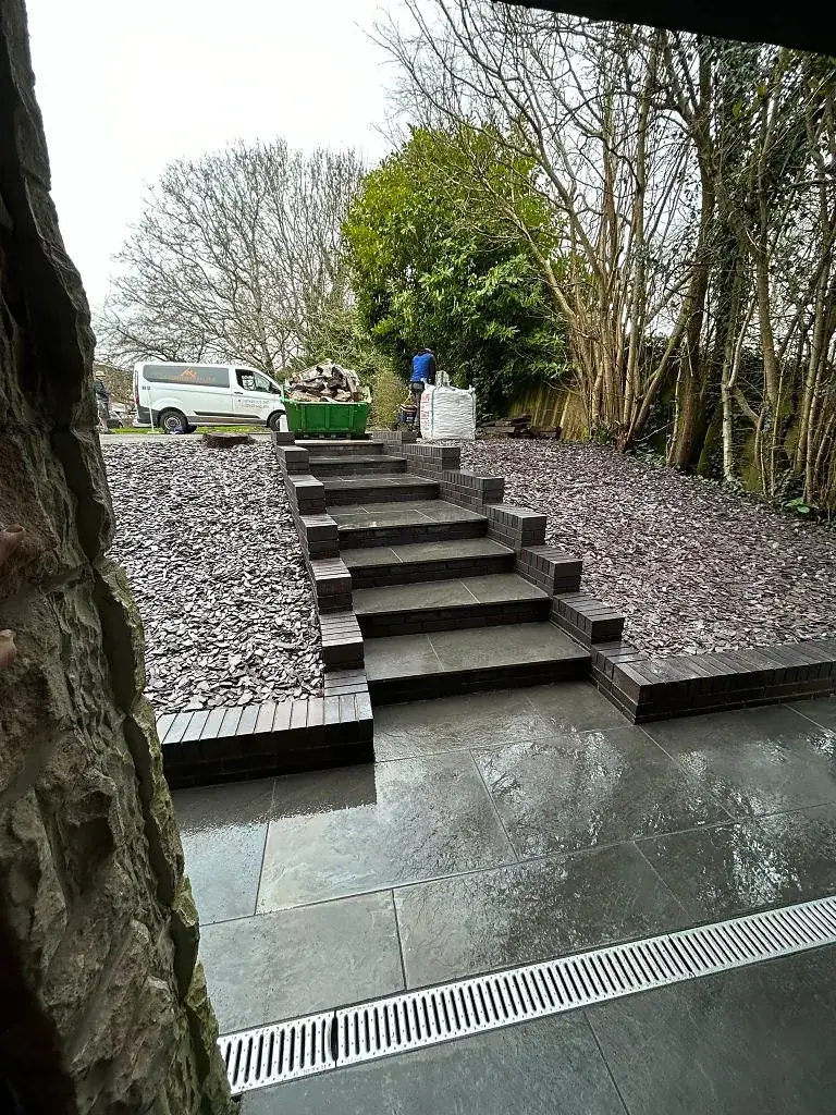 Slate steps running up through a gravel garden