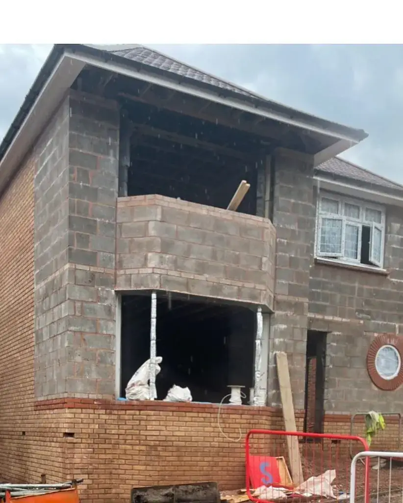 Blockwork shell of a two-storey extension with the openings formed